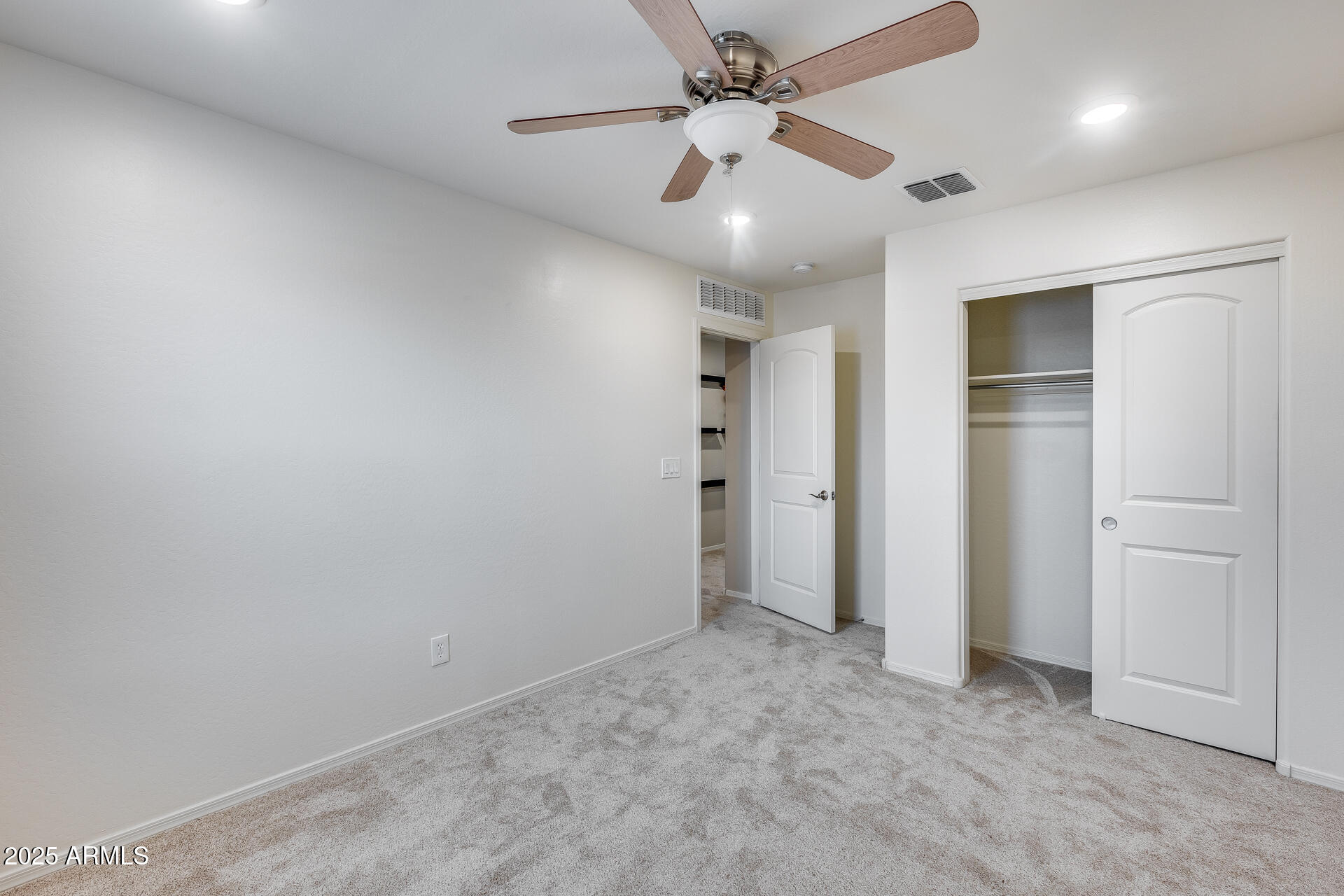6853 East Posada Circle Mesa, AZ 85212 - Photo 34 of 45 an empty room with closet and a ceiling fan