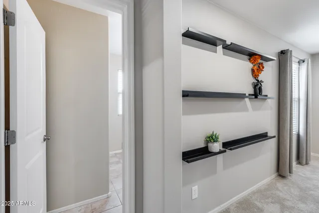 an empty room with closet and a ceiling fan