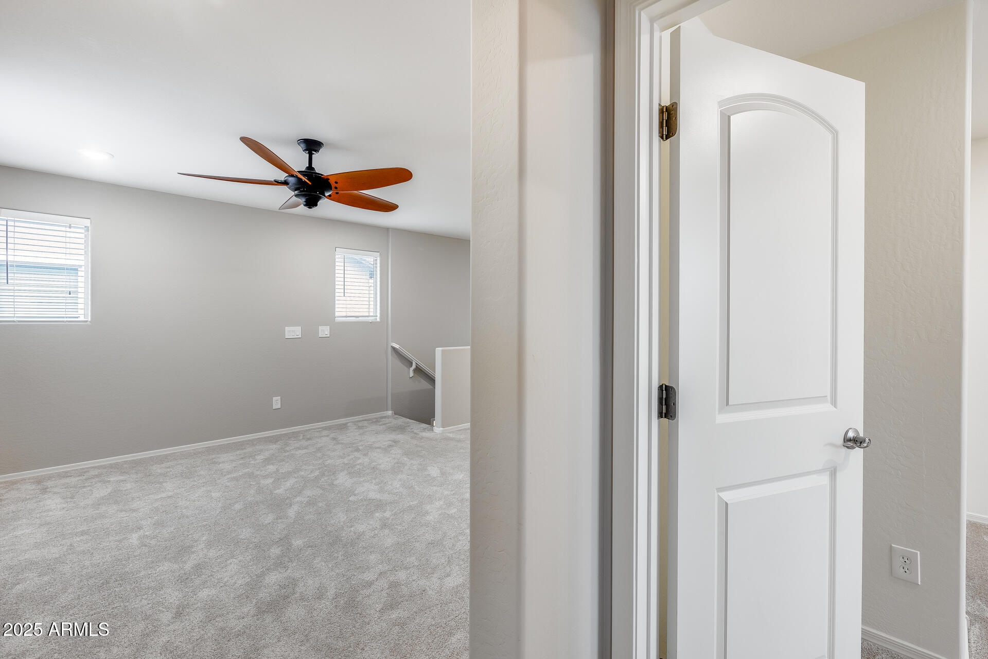 6853 East Posada Circle Mesa, AZ 85212 - Photo 36 of 45 a view of a livingroom with a ceiling fan and wooden floor