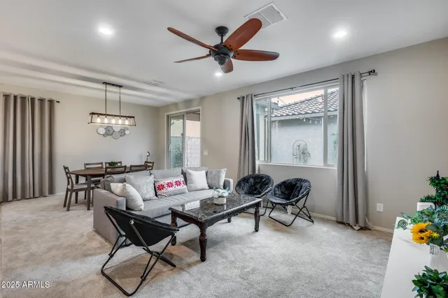 a kitchen with stainless steel appliances granite countertop a stove top oven a sink dishwasher a dining table and chairs