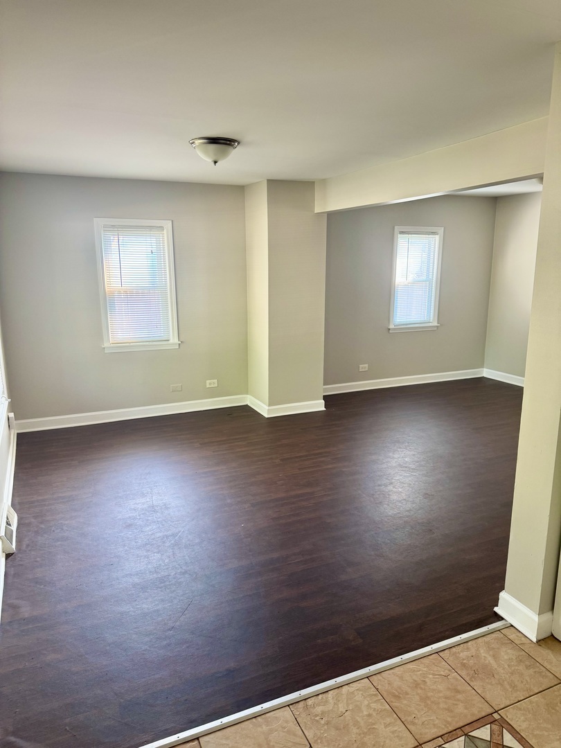 14503 Waverly Avenue Midlothian, IL 60445 - Photo 3 of 37 an empty room with wooden floor and windows