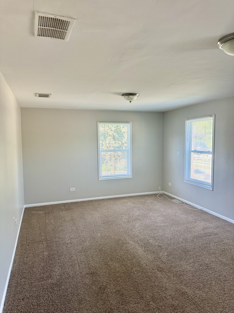 14503 Waverly Avenue Midlothian, IL 60445 - Photo 9 of 37 an empty room with windows
