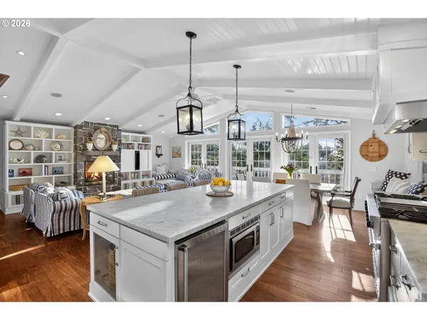 a kitchen with stainless steel appliances kitchen island granite countertop a table and chairs