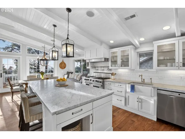 a kitchen with sink stove and cabinets
