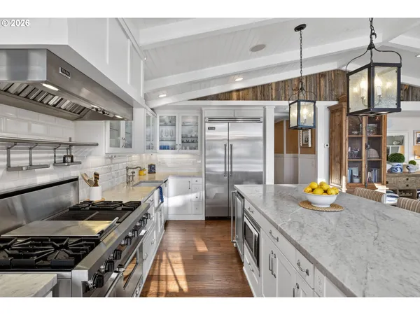 a kitchen with stainless steel appliances granite countertop a stove and cabinets