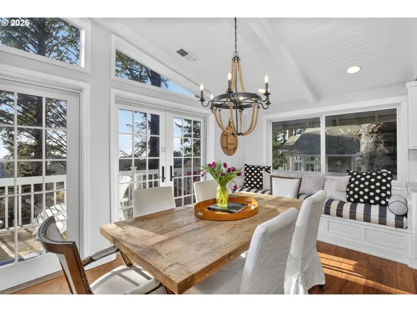a view of a dining room with furniture a chandelier and wooden floor