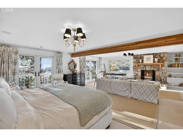 a bedroom with a large bed and a chandelier