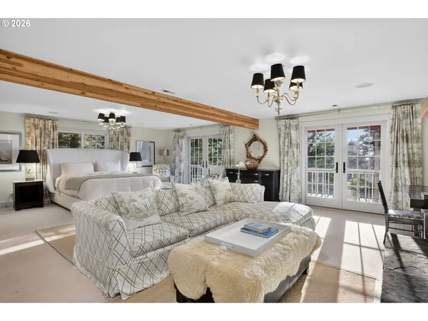 a living room with furniture ceiling fan and a large window