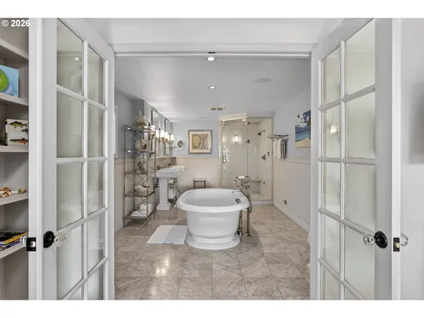 a bathroom with a bathtub shower sink mirror and toilet