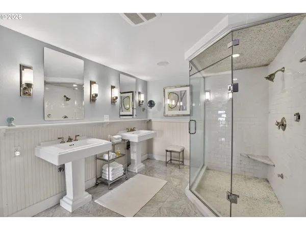 a bathroom with a sink mirror and a toilet