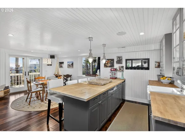 a large kitchen with a table and chairs