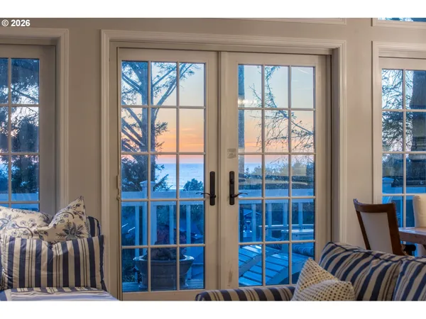 a bedroom with a bed and glass window