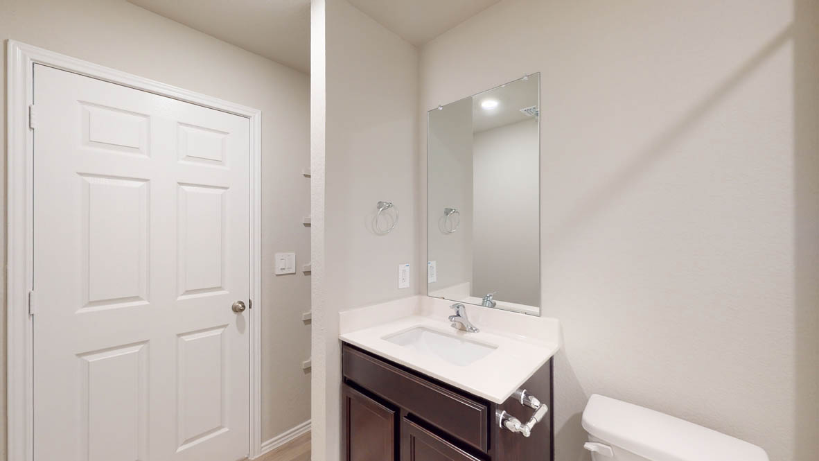 575 Hector Loop Georgetown, TX 78626 - Photo 26 of 28 Bathroom featuring a dark wood vanity with a white countertop and an undermount sink
