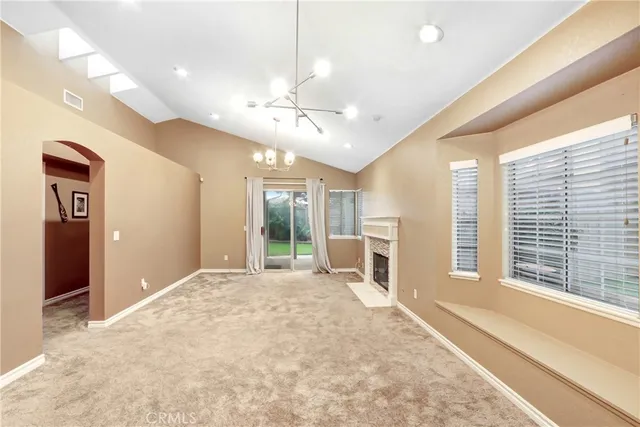 a large white room with a large window and chandelier