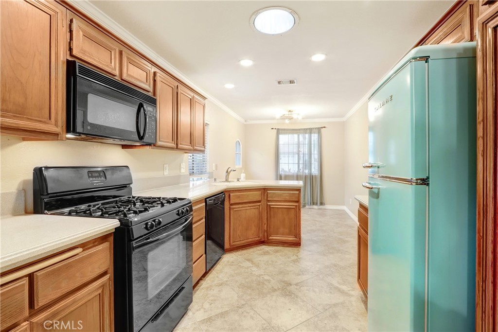 7622 Belpine Place Rancho Cucamonga, CA 91730 - Photo 6 of 15 a kitchen with a sink a stove and refrigerator