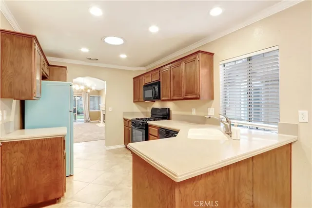 a kitchen with a sink a stove a refrigerator and a microwave