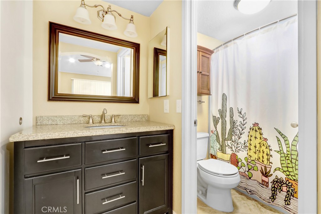 7622 Belpine Place Rancho Cucamonga, CA 91730 - Photo 10 of 15 a bathroom with a toilet a sink and a mirror