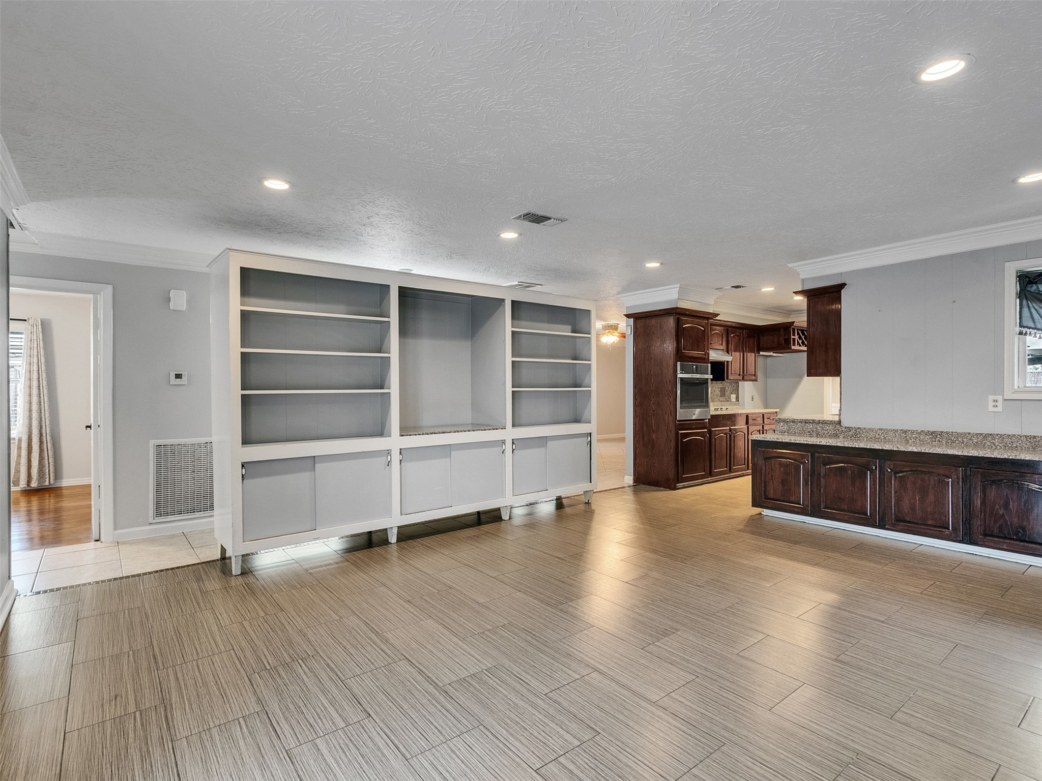 1630 Hollow Hook Road Houston, TX 77080 - Photo 11 of 22 a view of an empty room with wooden floor and windows
