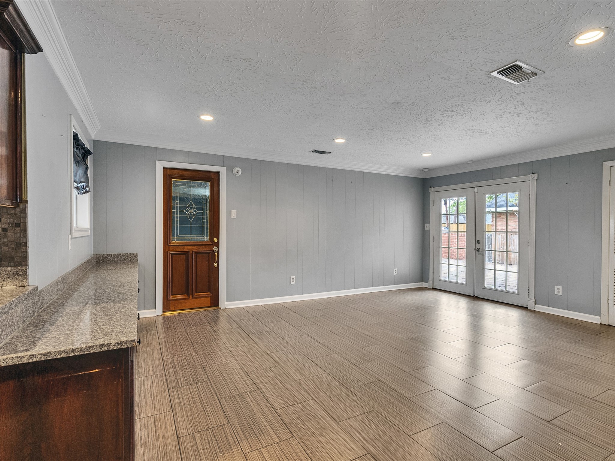 1630 Hollow Hook Road Houston, TX 77080 - Photo 12 of 22 a view of an empty room with glass door and wooden floor