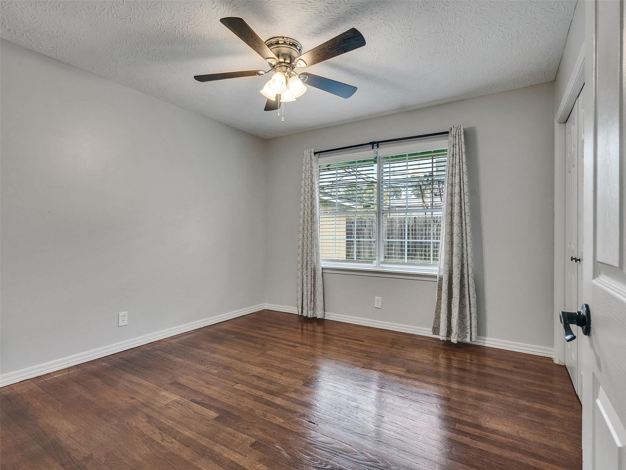 1630 Hollow Hook Road Houston, TX 77080 - Photo 16 of 22 an empty room with wooden floor and windows