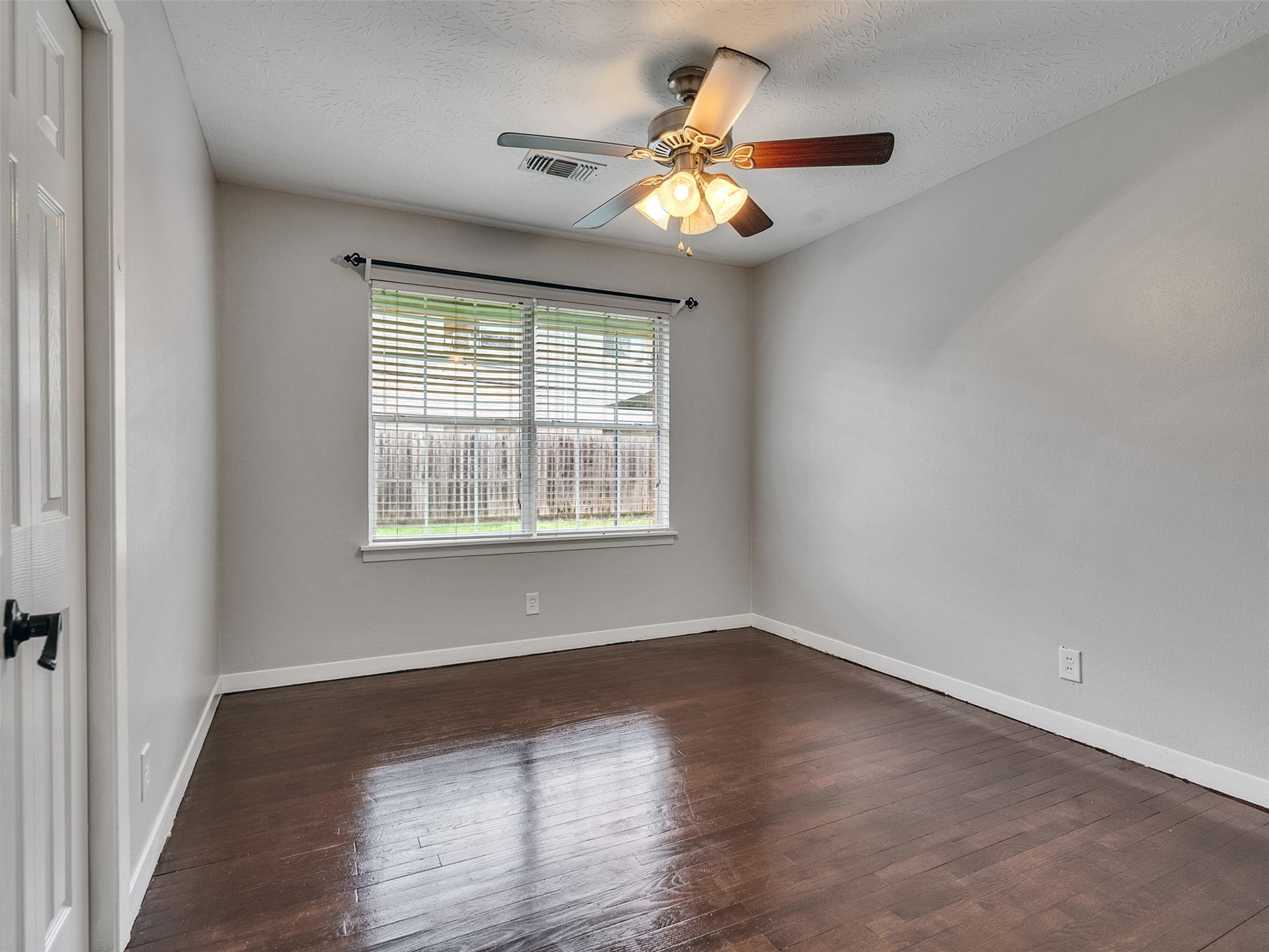 1630 Hollow Hook Road Houston, TX 77080 - Photo 17 of 22 an empty room with wooden floor and windows