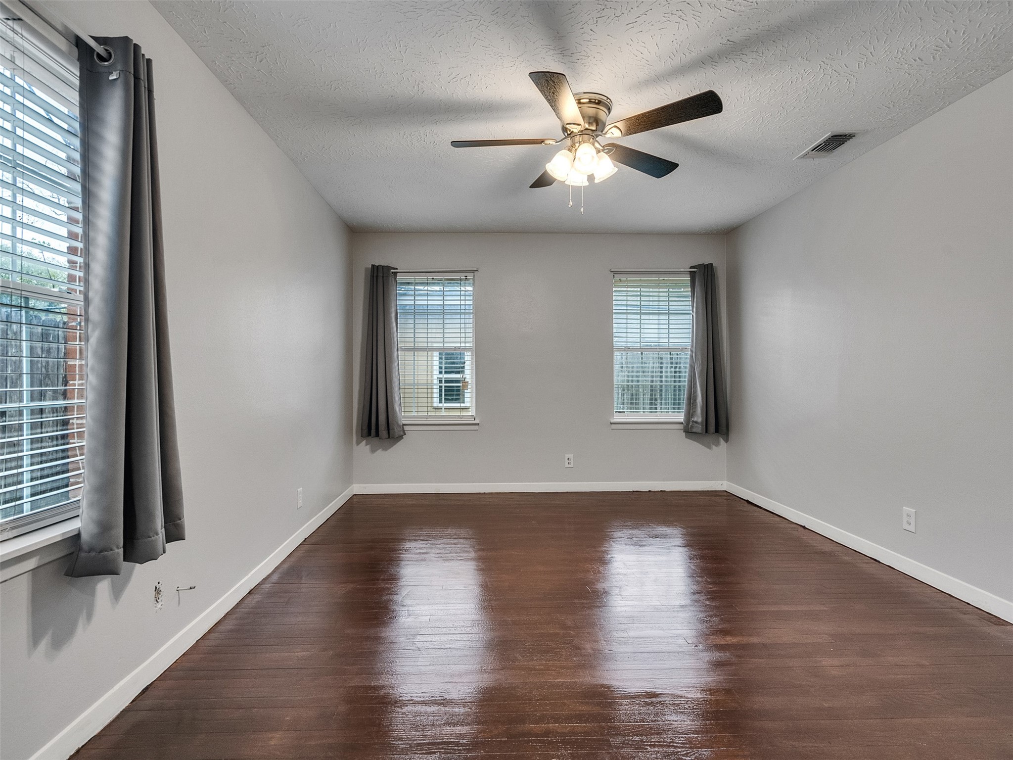1630 Hollow Hook Road Houston, TX 77080 - Photo 19 of 22 a view of an empty room with wooden floor and a window