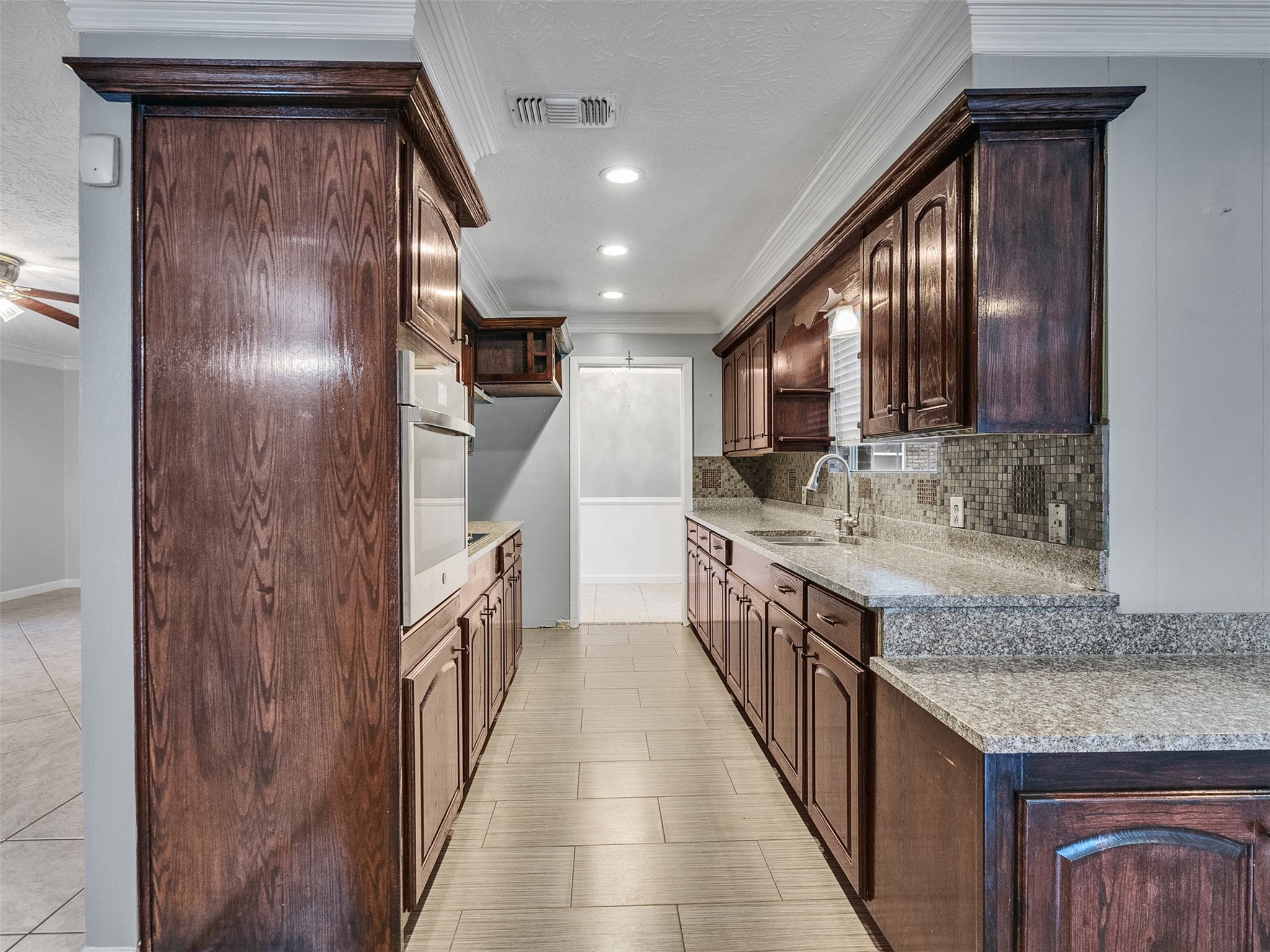 1630 Hollow Hook Road Houston, TX 77080 - Photo 9 of 22 a kitchen with granite countertop stainless steel appliances a sink and a refrigerator