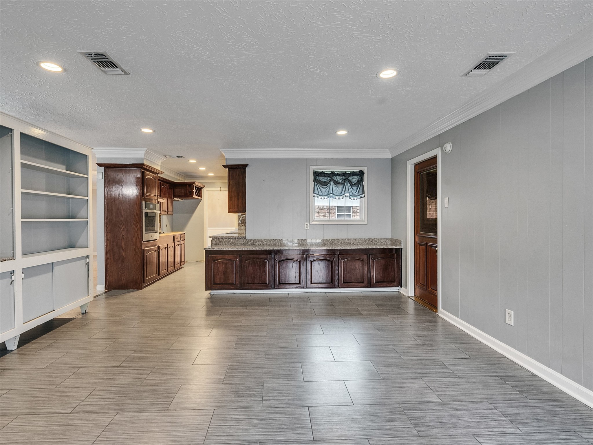 1630 Hollow Hook Road Houston, TX 77080 - Photo 10 of 22 a large hall with white walls and wooden floor