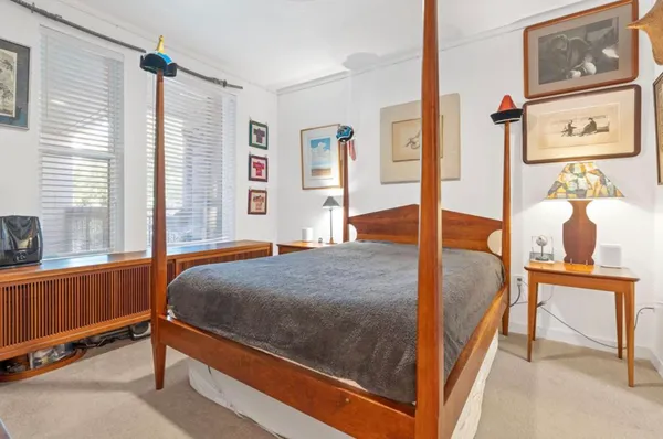 a bedroom with a bed and window