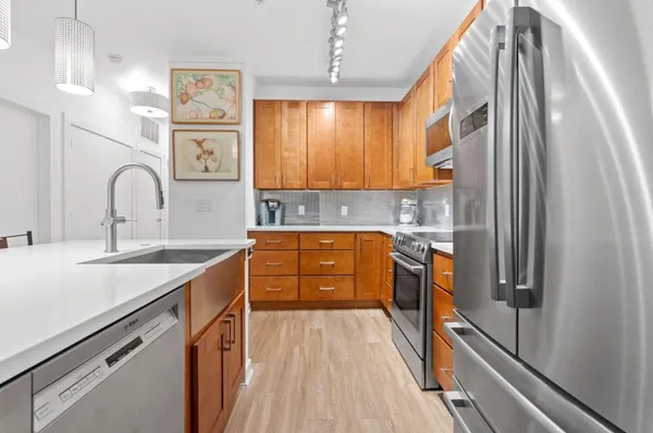 a kitchen with stainless steel appliances a sink stove and refrigerator