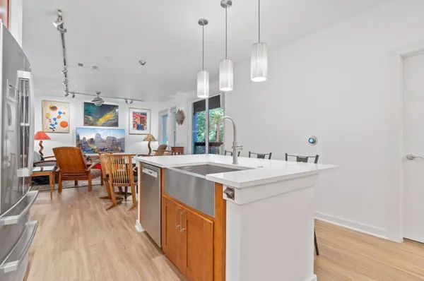 a open kitchen with stainless steel appliances granite countertop a stove and refrigerator