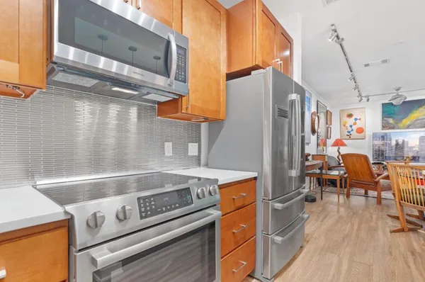 a kitchen with a stove and a refrigerator