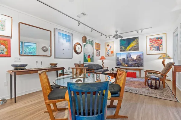 a view of a dining room with furniture and wooden floor