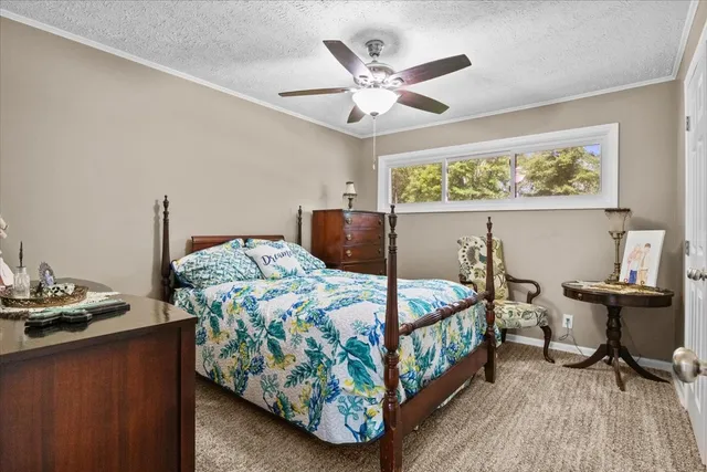 a bedroom with a bed and a table