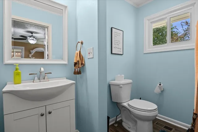 a bathroom with a sink mirror and toilet