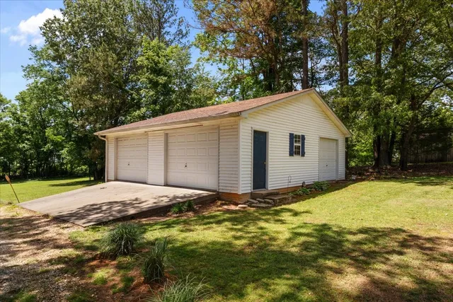 a view of backyard of house with green space