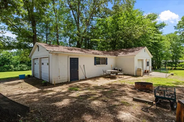 a view of a house with backyard and sitting area
