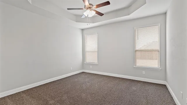 a view of kitchen with furniture and a chandelier fan