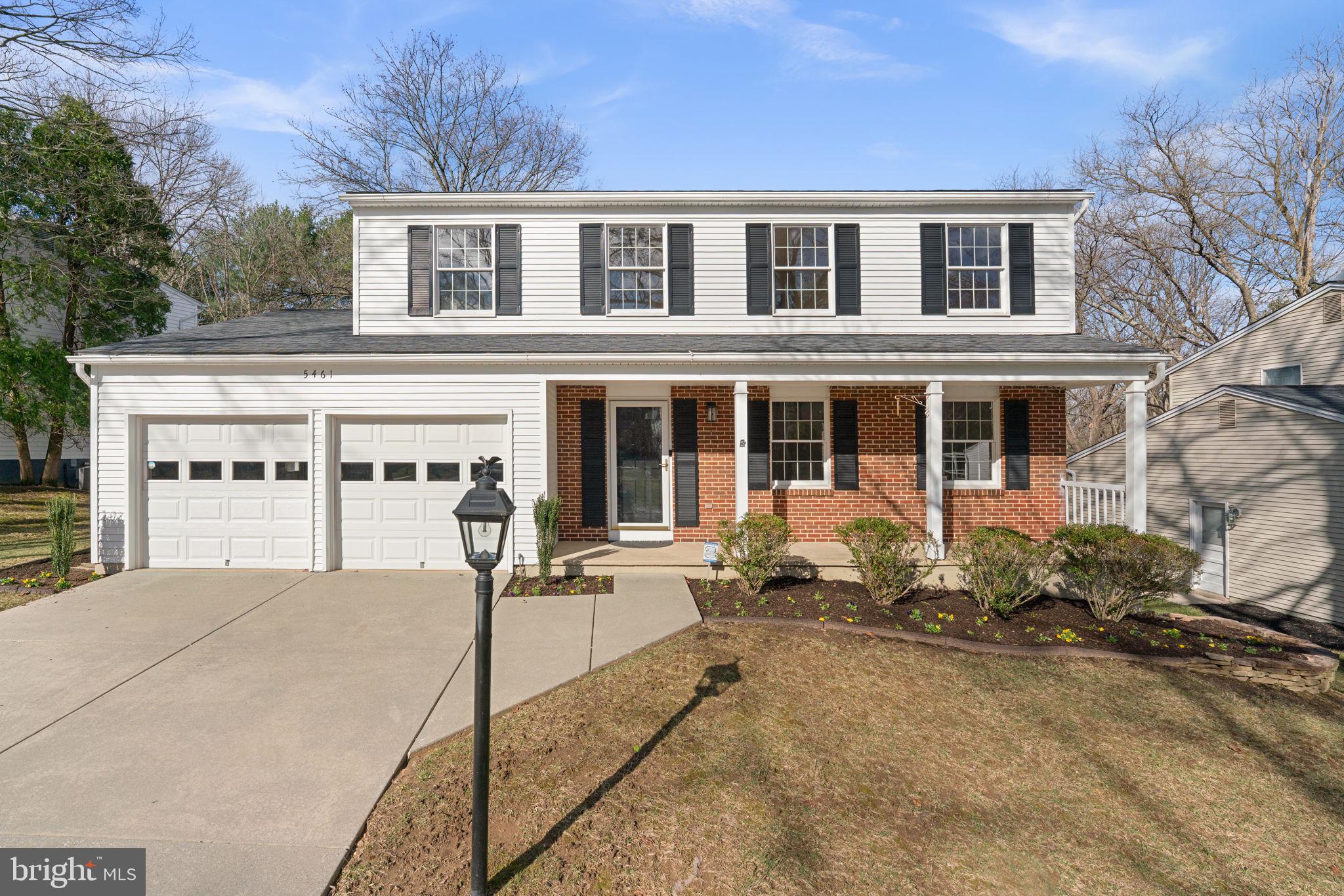 a front view of a house with yard patio and porch