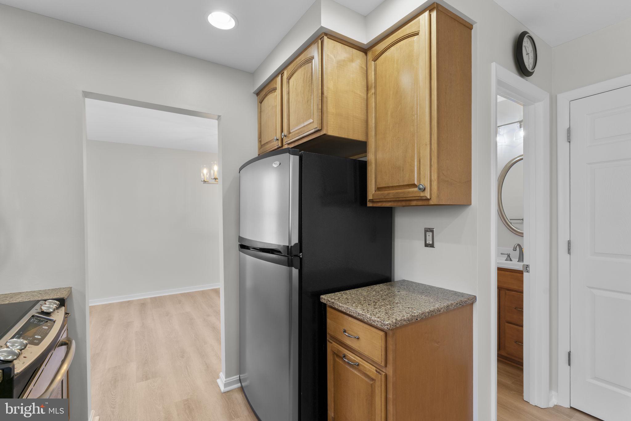 5461 Marsh Hawk Way Columbia, MD 21045 - Photo 11 of 48 a kitchen with stainless steel appliances granite countertop a refrigerator and a stove top oven