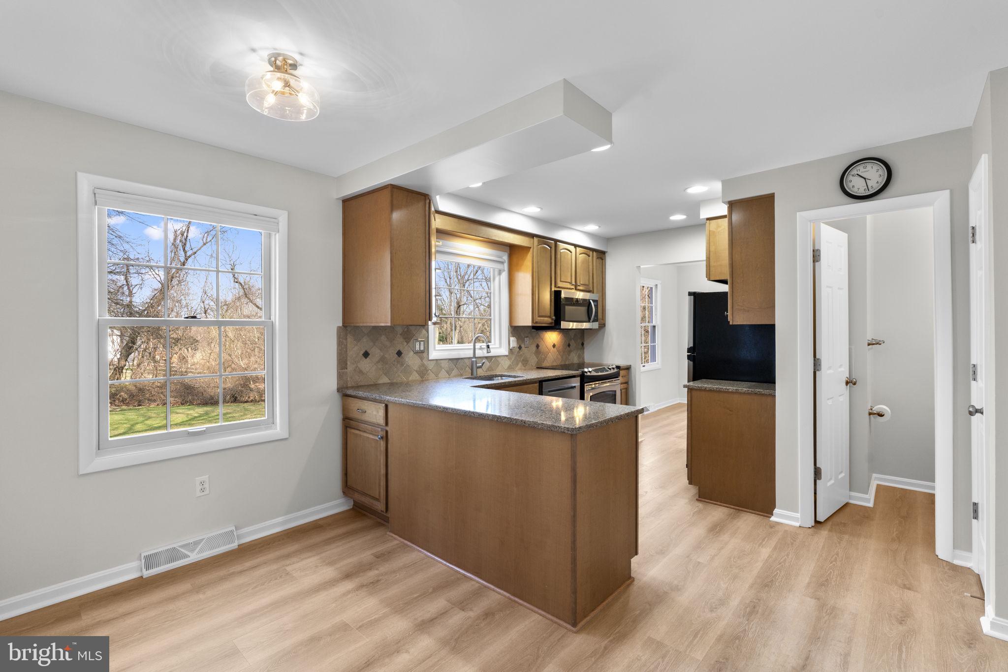 5461 Marsh Hawk Way Columbia, MD 21045 - Photo 13 of 48 a kitchen with stainless steel appliances granite countertop a refrigerator and a stove top oven