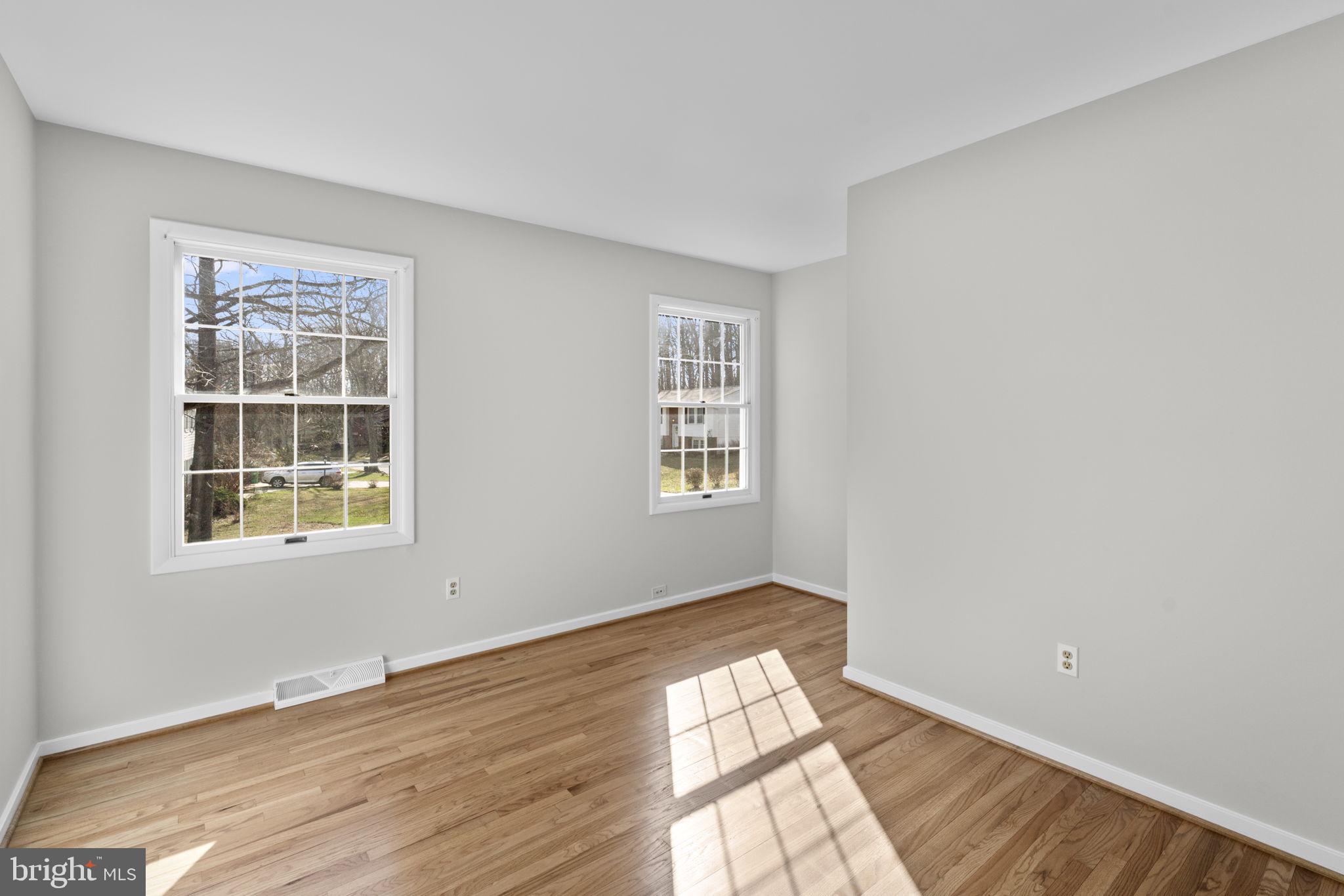 5461 Marsh Hawk Way Columbia, MD 21045 - Photo 25 of 48 a view of an empty room with wooden floor and windows