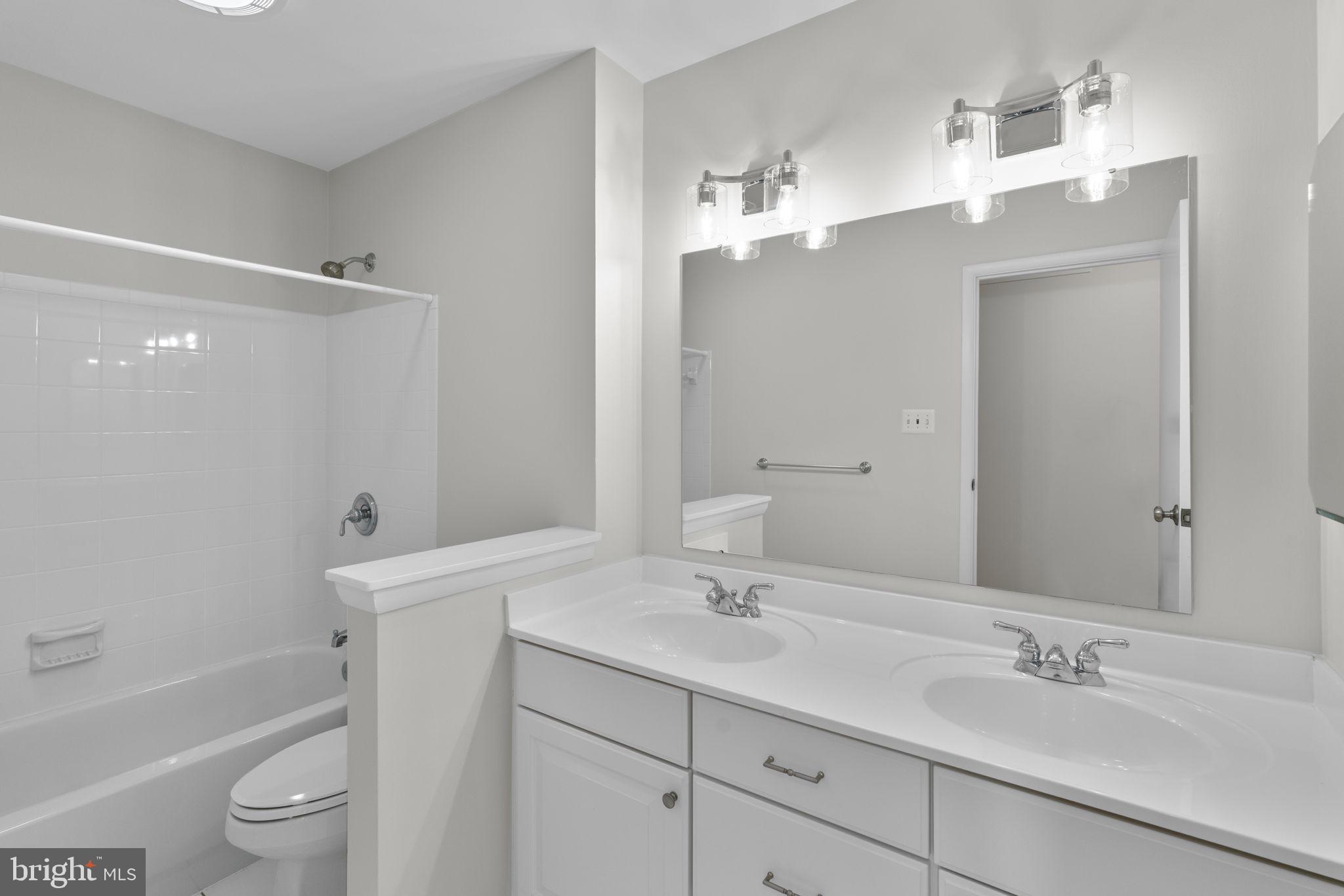 5461 Marsh Hawk Way Columbia, MD 21045 - Photo 26 of 48 a bathroom with a sink a toilet and shower