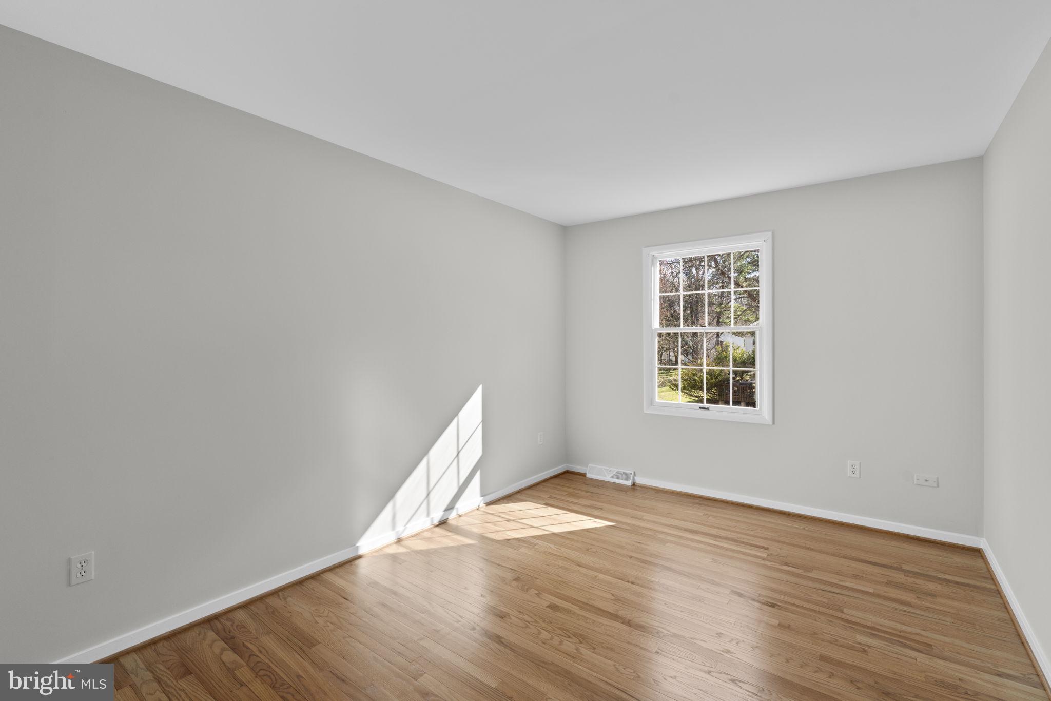 5461 Marsh Hawk Way Columbia, MD 21045 - Photo 29 of 48 an empty room with wooden floor and windows