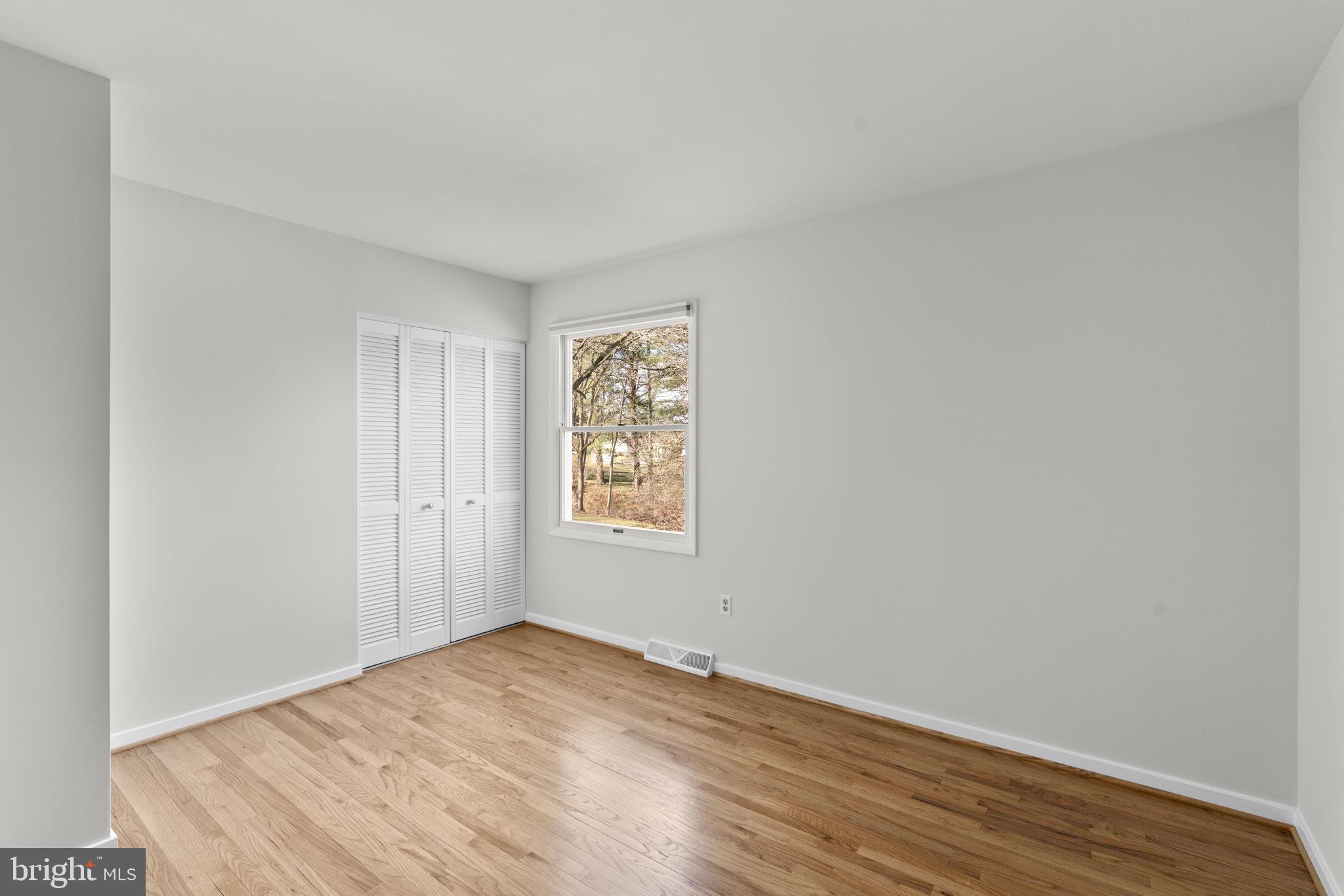 5461 Marsh Hawk Way Columbia, MD 21045 - Photo 31 of 48 an empty room with wooden floor and window