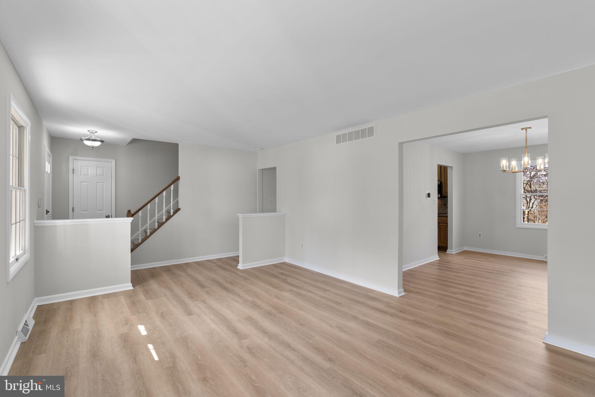 5461 Marsh Hawk Way Columbia, MD 21045 - Photo 6 of 48 a view of an empty room with wooden floor and a window
