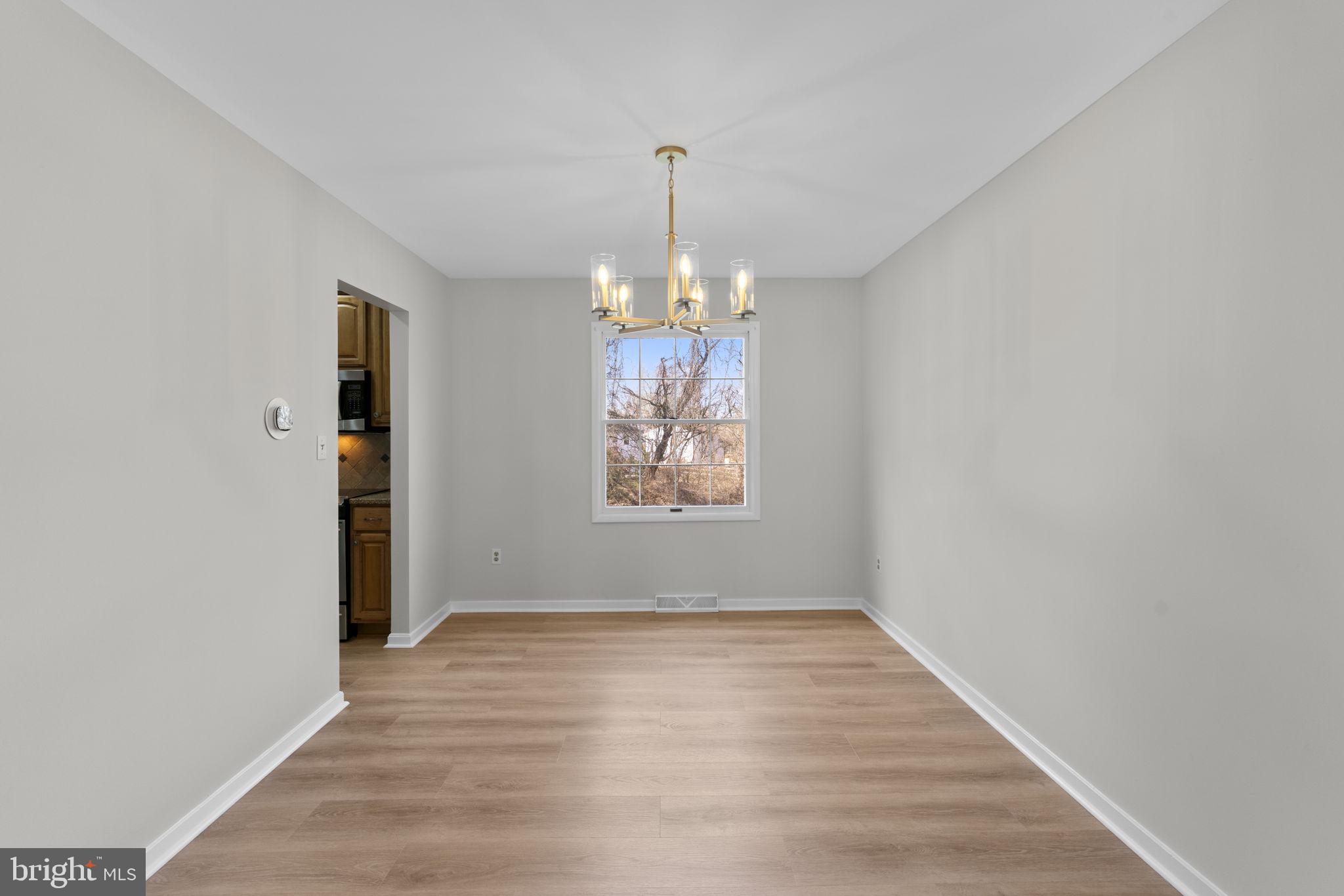 5461 Marsh Hawk Way Columbia, MD 21045 - Photo 7 of 48 wooden floor in an empty room with a window