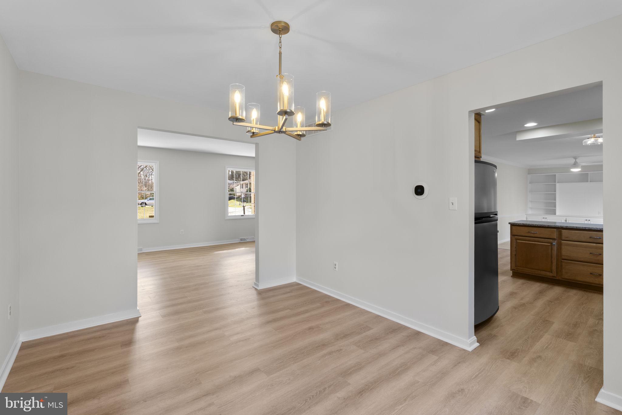 5461 Marsh Hawk Way Columbia, MD 21045 - Photo 9 of 48 a view of a hallway with wooden floor and a kitchen