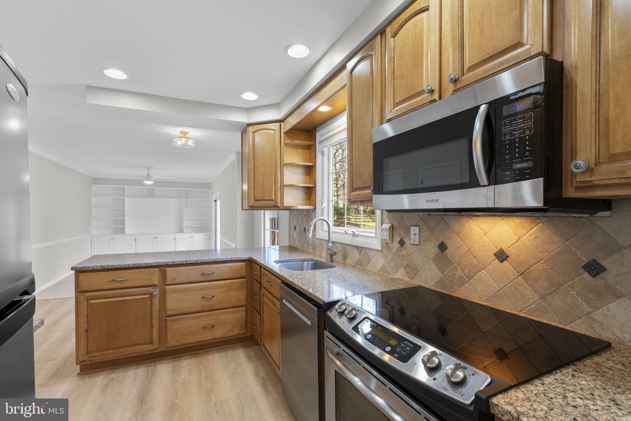 5461 Marsh Hawk Way Columbia, MD 21045 - Photo 10 of 48 a kitchen with a sink a stove and cabinets