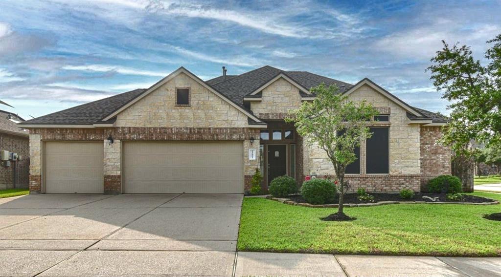 Gorgeous stone and brick home on huge corner lot with 3 car garage!
